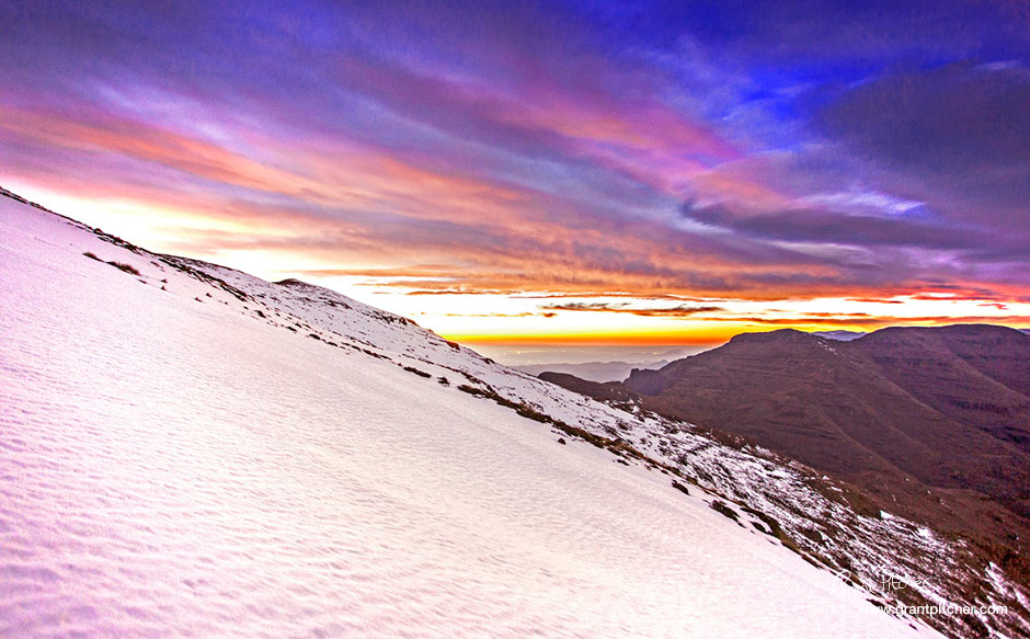 Sunrise on day 3 looking over the snow on the shadow side of Cleft Peak towards Organ Pipes Pass in the distance.